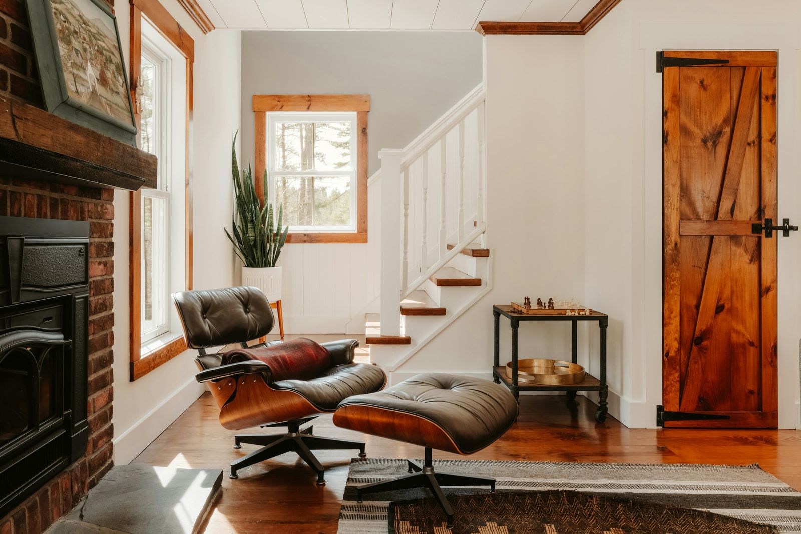 Brick fireplace with an insert beside a lounge chair
