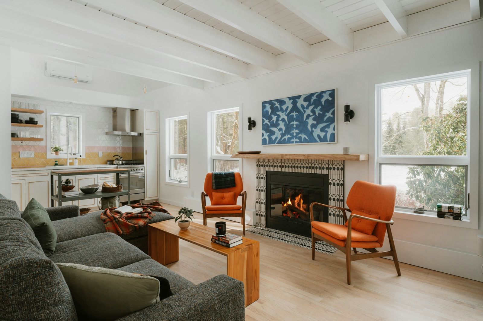 Gas fireplace burning in a tiled surround in a bright living room