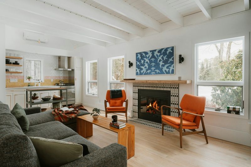 Gas fireplace burning in a tiled surround in a bright living room