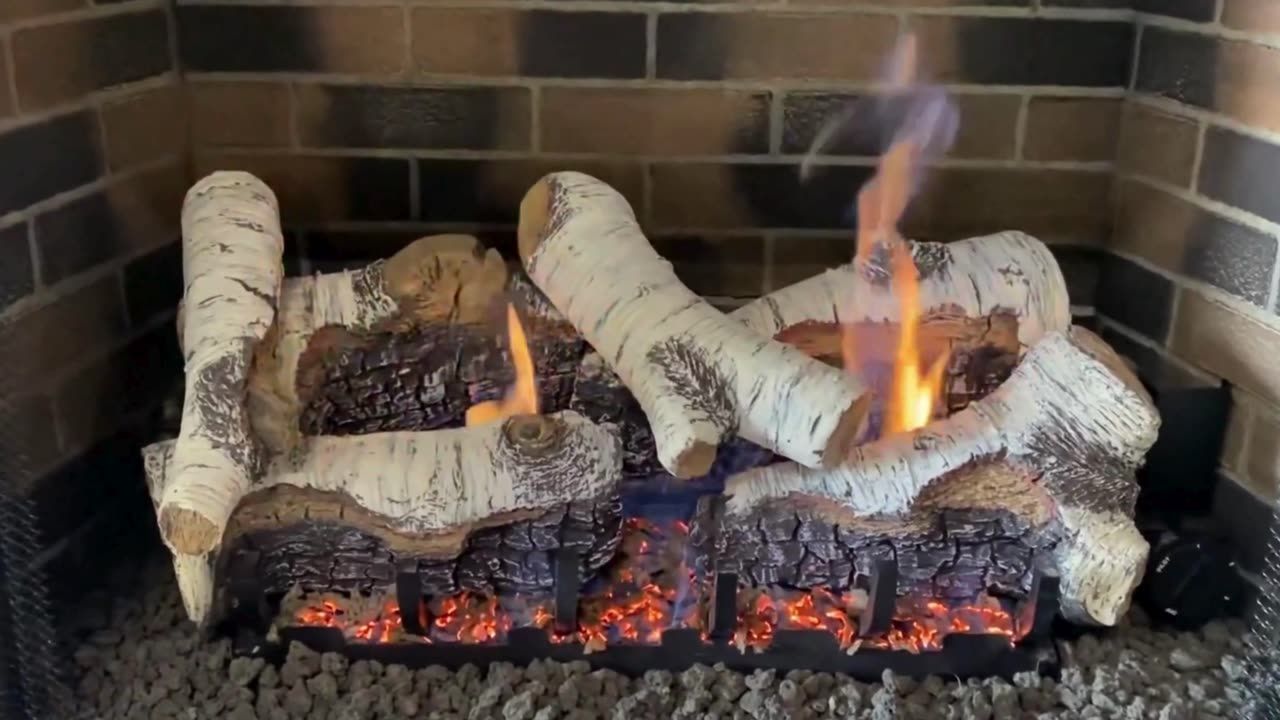 White birch gas log set burning in a newly installed fireplace