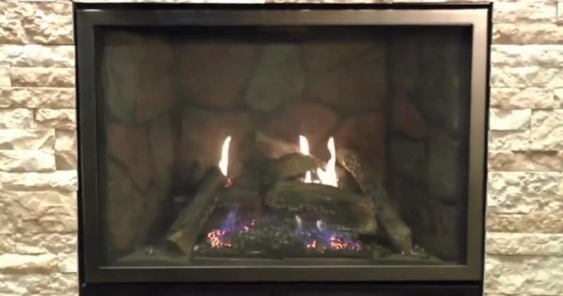 Direct-vent fireplace with a stone liner, set into a stacked-stone wall